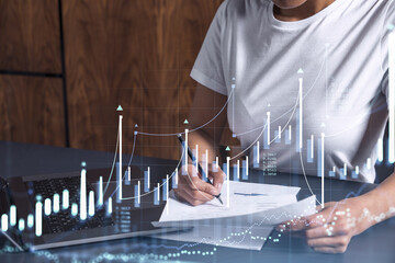 Wall Mural - A client in casual wear is signing the contract to invest money in stock market. Internet trading and wealth management. Forex and financial hologram chart over the desk. Women in business concept.