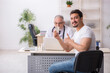 © Elnur - Old male doctor suggesting pills to young male patient