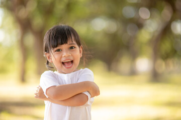 Happy little asian girl having fun at the park