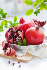 Sticker - Fresh Pomegranates with leaves on table