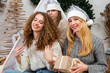 © ako-photography - young girls having fun wrapping gifts at home, great teamwork of friends packing presents for christmas
