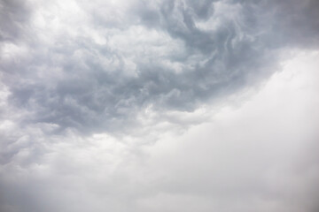 Wall Mural - overcast weather above dark grey sky. aggressive rain clouds floating before thunder storm, abstract