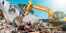 Demolition Of Building. Excavator Breaks Old House. Freeing Up Space For Construction Of New Building.