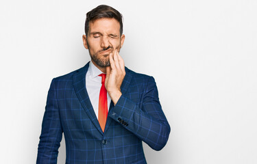 Canvas Print - Handsome man with beard wearing business suit and tie touching mouth with hand with painful expression because of toothache or dental illness on teeth. dentist