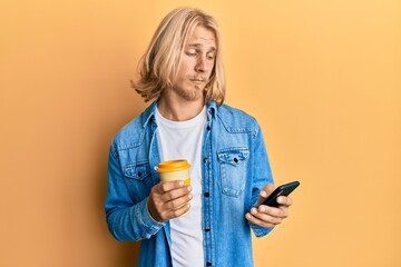 Poster - Caucasian young man with long hair using smartphone and drinking a cup of coffee skeptic and nervous, frowning upset because of problem. negative person.