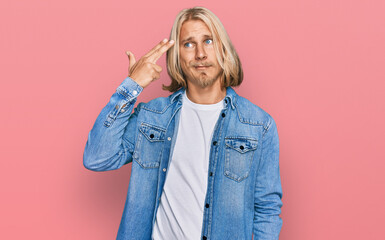 Sticker - Caucasian man with blond long hair wearing casual denim jacket shooting and killing oneself pointing hand and fingers to head like gun, suicide gesture.