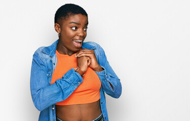 Poster - Young african american woman wearing casual clothes laughing nervous and excited with hands on chin looking to the side