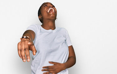 Poster - Young african american woman wearing casual white t shirt laughing at you, pointing finger to the camera with hand over body, shame expression