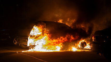 car in flames at night