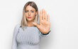 © Krakenimages.com - Beautiful blonde woman wearing casual clothes doing stop sing with palm of the hand. warning expression with negative and serious gesture on the face.