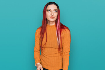 Young caucasian woman wearing casual clothes smiling looking to the side and staring away thinking.