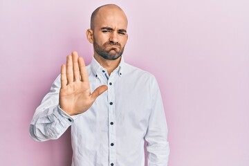 Sticker - Young hispanic man wearing casual clothes doing stop sing with palm of the hand. warning expression with negative and serious gesture on the face.