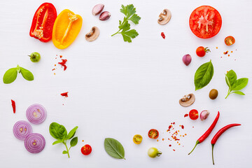 The ingredients for homemade pizza on white wooden background.