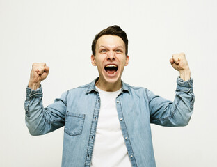 life style, happiness and people concept: young man showing hand up standing against grey background.