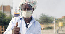 Old Indian Man Wearing A Face Mask And Showing Thumbs Up- New Normal Concept