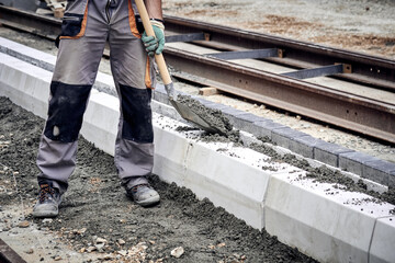 Wall Mural - Construction worker on a public road reconstruction.