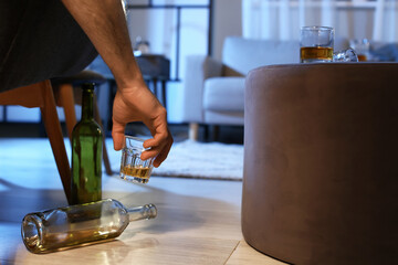 Poster - Senior man with glass of drink late in evening at home