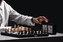 Senior Man Playing Chess On Dark Background, Closeup