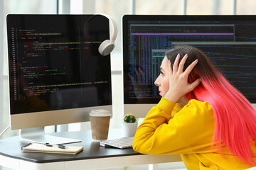 Wall Mural - Female programmer working with computer in office