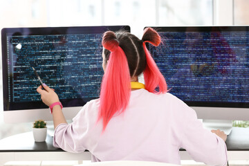 Wall Mural - Female programmer working with computer in office