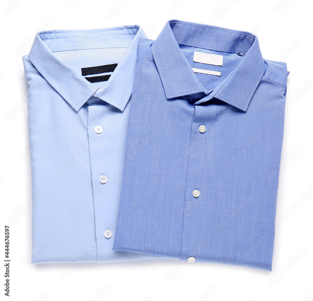 Stylish male shirts on white background