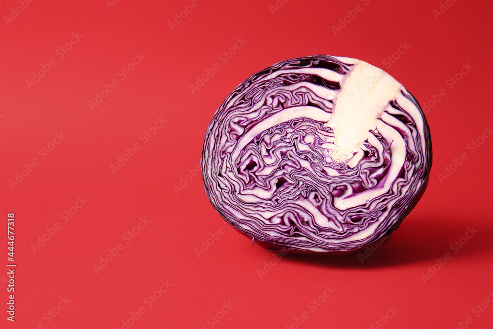Half of fresh purple cabbage on color background