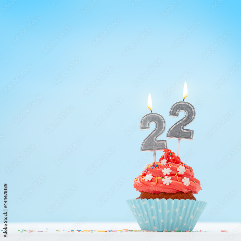 Christmas card with cupcakes, and new year 22 candles - obrazy, fototapety, plakaty 
