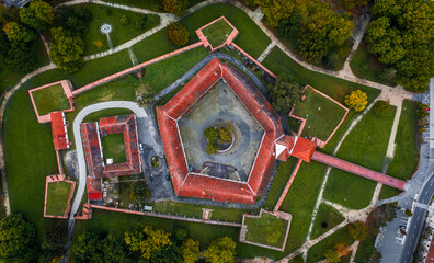 Wall Mural - Sarvar, Hungary - Aerial topdown view of the Castle of Sarvar (Nadasdy castle)  with green coloured trees and foliage on a calm autumn morning