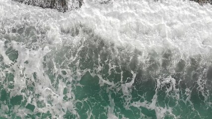 Poster - drone camera zooms down on the waves of the surf in slow motion. Sea surf foaming close-up