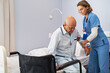 © Rido - Nurse helping senior patient at clinic