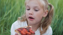 Cute Little Girl Eating Chewing Chocolate Sandwich With Strawberry On Outdoor Picnic