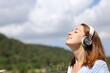 © Antonioguillem - Woman meditating listening audio guide on headphones