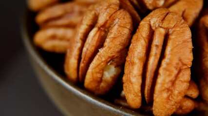 Wall Mural - Pecan nut close-up in a brown cup.Rotation.Organic Fresh Pecans.slow motion