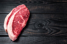 Raw Rump Steak Or Top Sirloin Cap Beef Meat Steaks On Butcher Table. Black Wooden Background. Top View. Copy Space