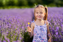 Little Girl With Lollipop In Lavender Garden