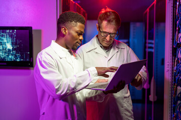 Poster - Multi-ethnic IT Engineers Analyzing Data on Laptop