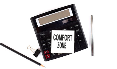 Poster - COMFORT ZONE text on sticker on calculator with pen,pencil on the white background