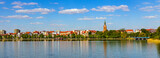Fototapeta  - Panorama of Elk historic city center with Holiest Heart of Jesus neo-gothic church tower on shore of Jezioro Elckie lake in Masuria region in Poland
