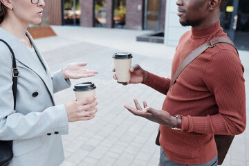 Aufkleber - Two young intercultural colleagues with coffee interacting outdoors