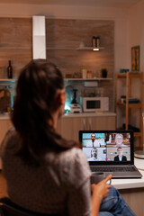 Poster - Woman talking with coworkers during video conference at midnight from home holding a cup of coffee. Corporate meeting using modern technology, laptop late at night , tech, agency, advisor, work