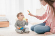 © InsideCreativeHouse - Happy mother nanny babysitter playing games with little small kid child toddler newborn baby infant, developing skills and imagination, learning educating son daughter before kindergarten. Motherhood