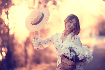 Wall Mural - happy romantic girl in a straw hat / young model in a dress summer day, happiness woman