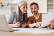 © InsideCreativeHouse - Mature middle-aged couple wife and husband family doing paperwork, paying bills, pension, financial documents operations, divorce contract, bankruptcy, court case, health problems at home.