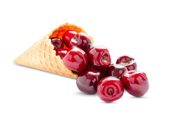 Wall Mural - ripe cherry berries in a waffle cone on a white background