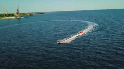 Poster - A motor boat takes tourists on the sea waves.