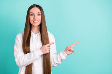 Wall Mural - Portrait of attractive cheerful girl demonstrating copy empty place space ad idea isolated over bright teal turquoise color background