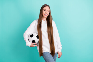 Poster - Photo of pretty charming young lady wear white sweatshirt holding football ball smiling isolated turquioise color background