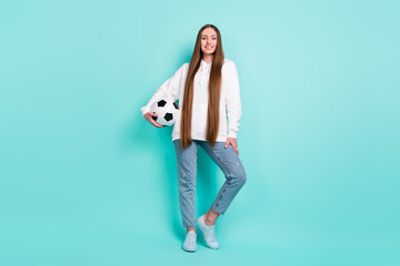 Wall Mural - Full length body size view of attractive cheerful girl holding ball posing isolated over bright teal turquoise color background