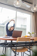 © snowing12 - Work from home concept a female entrepreneur being relaxed stretching her arms while working remotely in her house