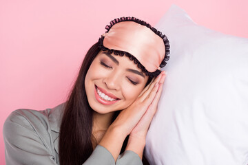 Portrait of attractive cute cheerful dreamy girl sleeping cosy comfy seeing dreams isolated over pink pastel color background